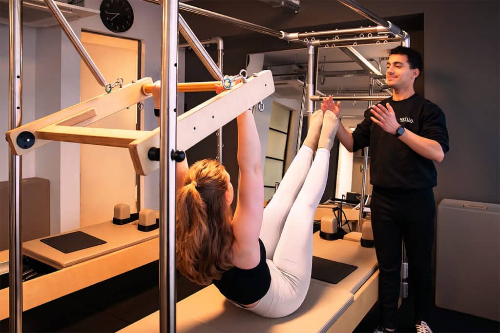 woman training on reformer pilates cadillac in amstelveen studio